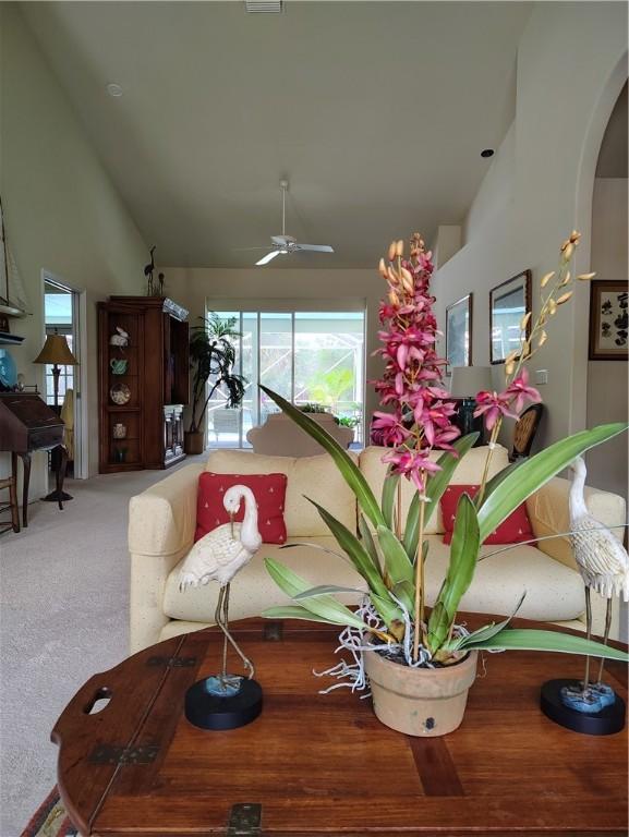 3932 58th Cir, Vero Beach, FL 32966 - carpeted living area with high vaulted ceiling and a ceiling fan