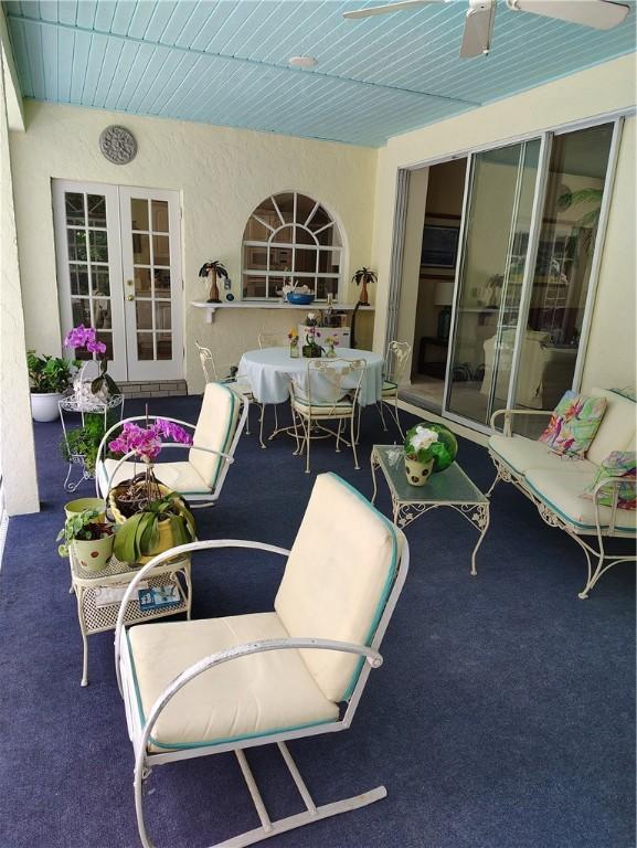 3932 58th Cir, Vero Beach, FL 32966 - view of patio / terrace featuring french doors and outdoor dining area