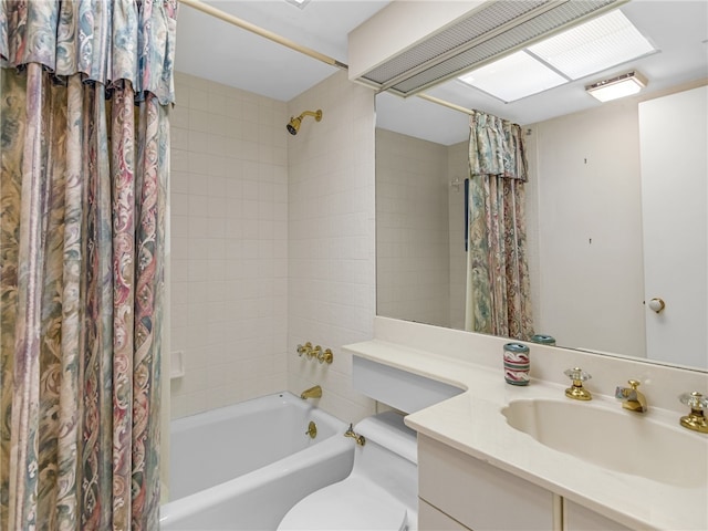 full bathroom featuring shower / tub combo with curtain, vanity, and toilet