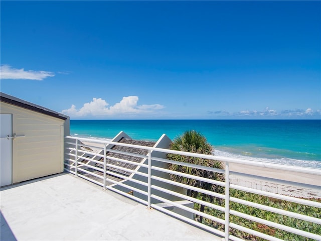 balcony with a view of the beach and a water view