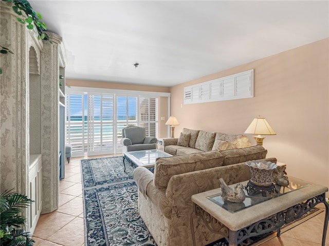 tiled living room featuring a water view