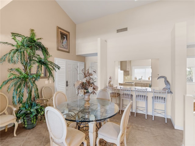 8444 Oceanside Dr Unit D31, Indian River Shores, FL 32963 - dining area with plenty of natural light, light tile patterned flooring, and lofted ceiling