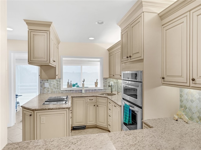 8444 Oceanside Dr Unit D31, Indian River Shores, FL 32963 - kitchen featuring cream cabinetry, a sink, stainless steel double oven, stovetop with downdraft, and recessed lighting
