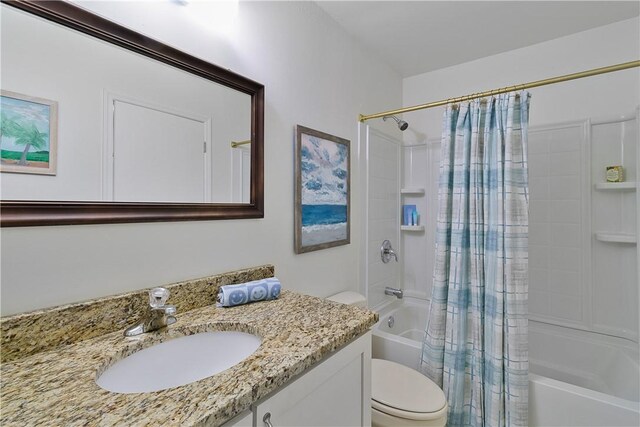 full bathroom featuring shower / bath combo with shower curtain, vanity, and toilet