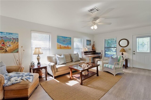 living room featuring light wood-type flooring and ceiling fan