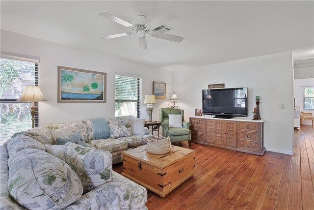 living room featuring hardwood / wood-style flooring and ceiling fan