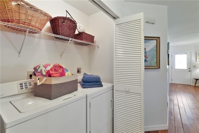 washroom featuring hardwood / wood-style floors and separate washer and dryer