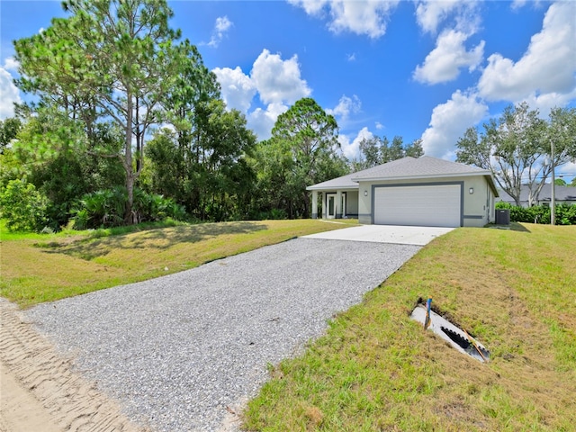 single story home featuring a front yard and a garage