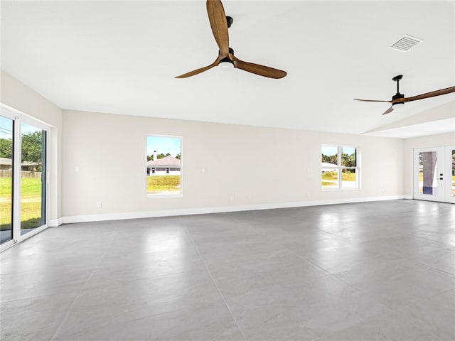 empty room with ceiling fan, french doors, and vaulted ceiling