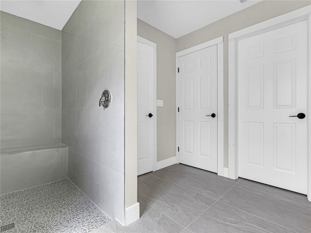 bathroom with tiled shower