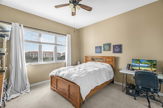 bedroom featuring ceiling fan and light carpet