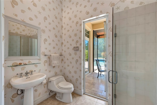 bathroom with toilet and a shower with door