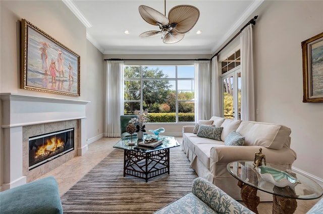 living room featuring a fireplace, tile patterned floors, ceiling fan, and crown molding