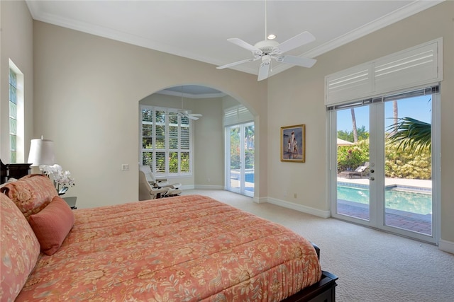 bedroom featuring access to outside, light colored carpet, multiple windows, and ceiling fan