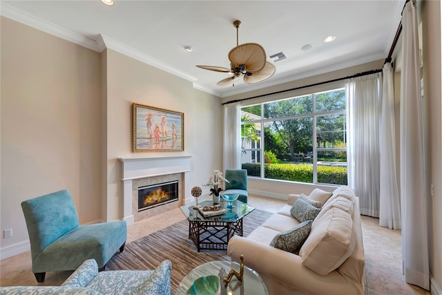 living room featuring a fireplace, ceiling fan, and ornamental molding