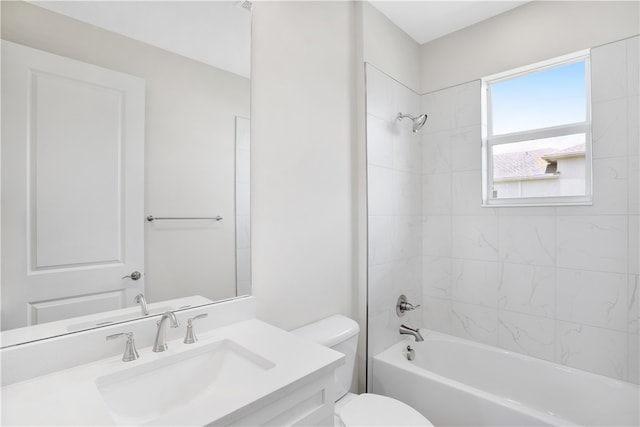 full bathroom featuring vanity, toilet, and tiled shower / bath combo