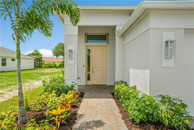 doorway to property with a yard