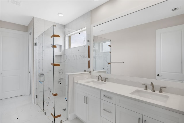 bathroom with walk in shower and vanity