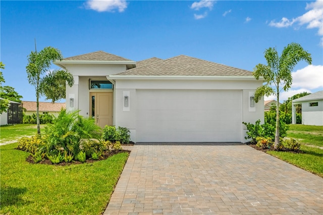 view of front of home with a garage and a front lawn