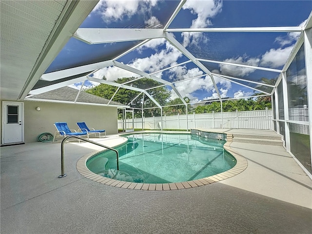 view of swimming pool featuring a lanai and a patio area