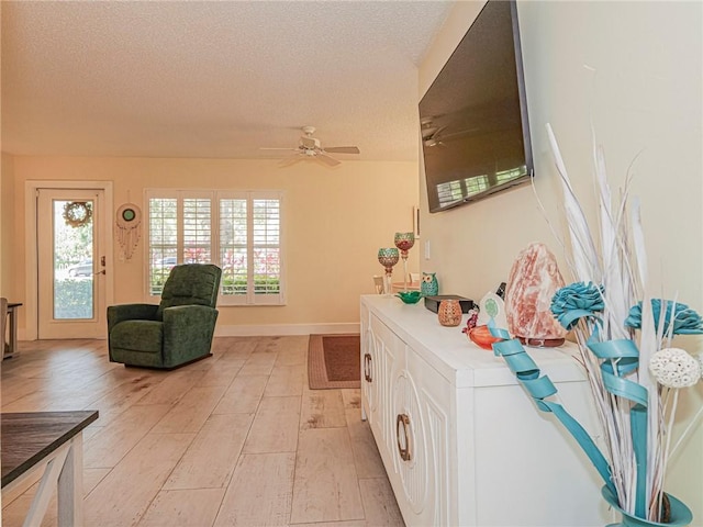 14 Vista Gardens Trl Unit 102, Vero Beach, FL 32962 - entrance foyer with a textured ceiling, ceiling fan, and baseboards