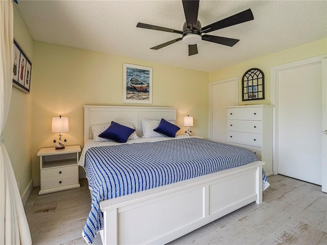 14 Vista Gardens Trl Unit 102, Vero Beach, FL 32962 - bedroom featuring wood finished floors, ceiling fan, and a textured ceiling