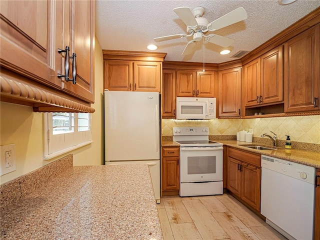 14 Vista Gardens Trl Unit 102, Vero Beach, FL 32962 - kitchen featuring white appliances, a sink, brown cabinets, tasteful backsplash, and a ceiling fan