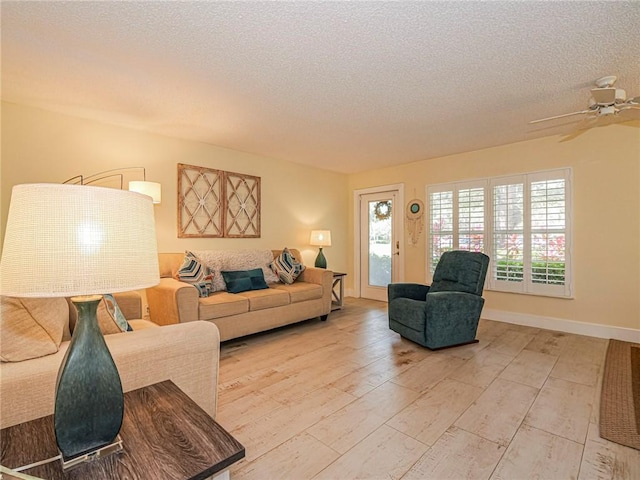 14 Vista Gardens Trl Unit 102, Vero Beach, FL 32962 - living area featuring light wood finished floors, a textured ceiling, ceiling fan, and baseboards