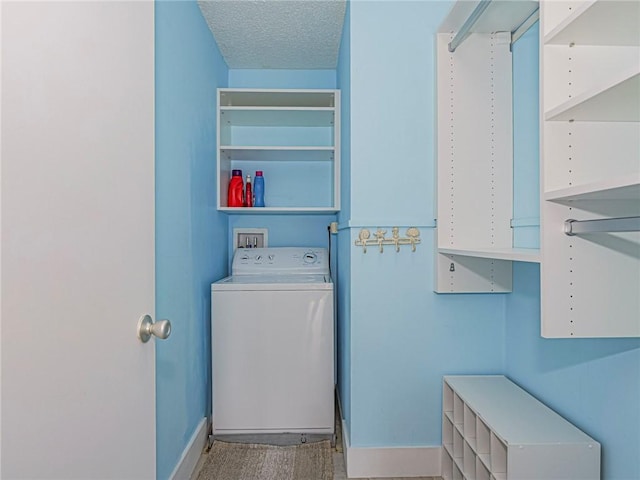 14 Vista Gardens Trl Unit 102, Vero Beach, FL 32962 - laundry room with washer / dryer, baseboards, and a textured ceiling