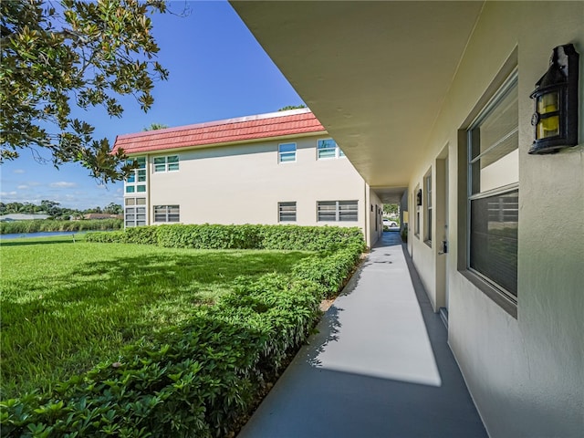 view of side of home featuring a lawn