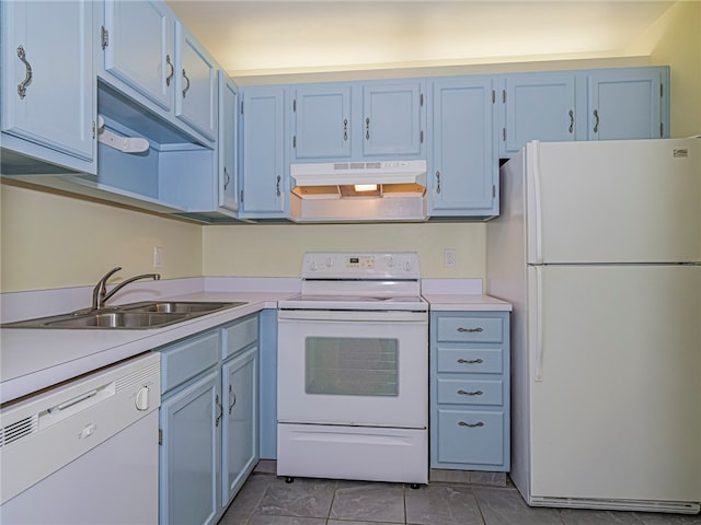 kitchen with blue cabinetry, tile patterned floors, sink, and white appliances