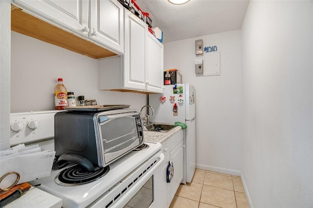 washroom featuring sink, light tile patterned flooring, electric panel, and separate washer and dryer