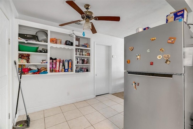 kitchen featuring ceiling fan, stainless steel fridge, and light tile patterned flooring