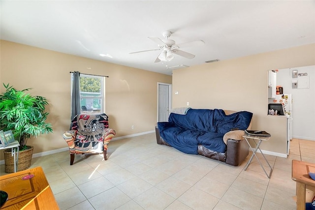 tiled living room with ceiling fan