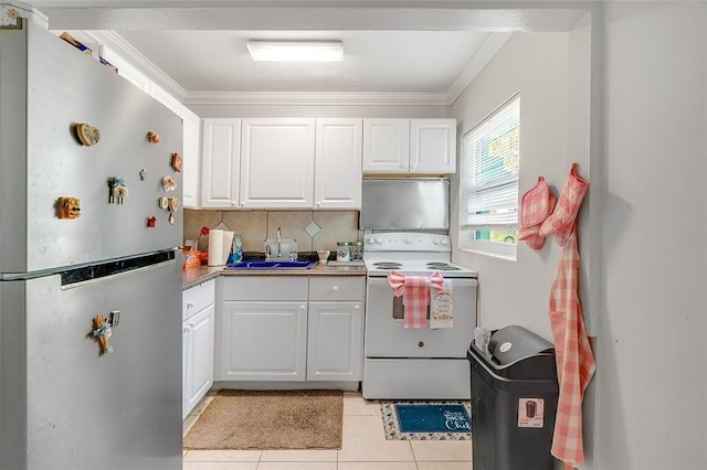 kitchen featuring white range with electric cooktop, sink, white cabinets, and stainless steel fridge