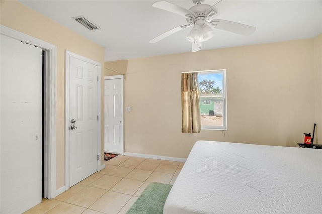 bedroom with ceiling fan and light tile patterned flooring