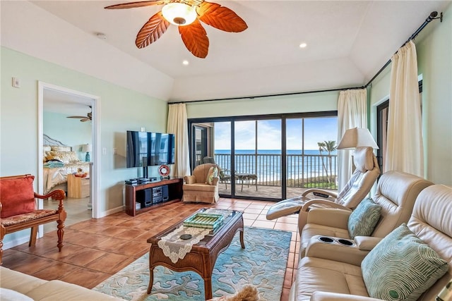 living room with light tile patterned floors, ceiling fan, and vaulted ceiling