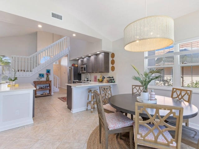 1880 Cobia Dr, Vero Beach, FL 32960 - dining room featuring high vaulted ceiling, recessed lighting, stairway, and baseboards