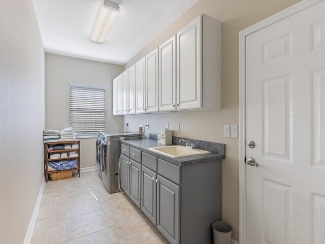 1880 Cobia Dr, Vero Beach, FL 32960 - clothes washing area featuring cabinet space, washing machine and clothes dryer, baseboards, and light tile patterned floors