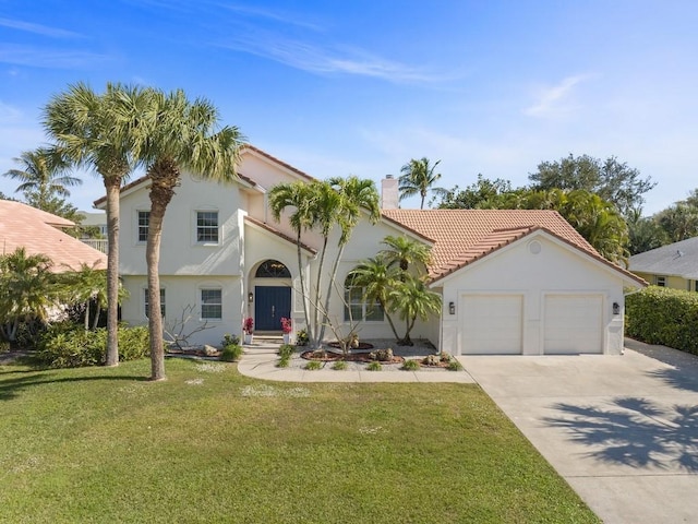 1880 Cobia Dr, Vero Beach, FL 32960 - mediterranean / spanish house with driveway, an attached garage, a chimney, and stucco siding