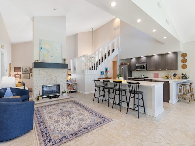 1880 Cobia Dr, Vero Beach, FL 32960 - kitchen with appliances with stainless steel finishes, open floor plan, a breakfast bar area, a high ceiling, and light countertops