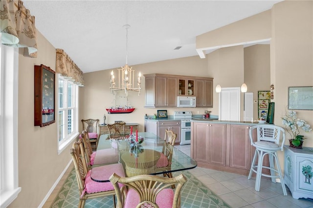 dining area with light tile patterned flooring, a chandelier, and vaulted ceiling