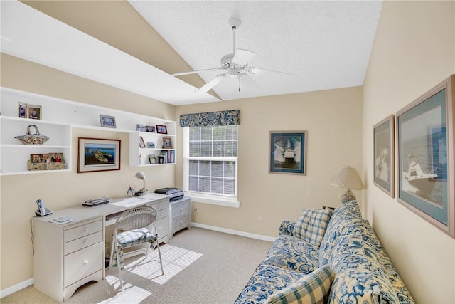 office with lofted ceiling, ceiling fan, light colored carpet, and a textured ceiling