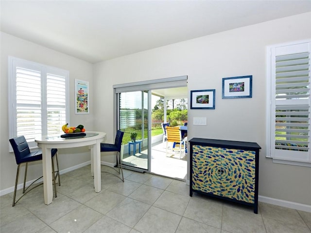 dining area with light tile patterned flooring and plenty of natural light