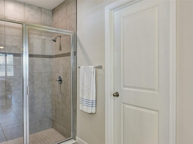 bathroom featuring a shower with shower door