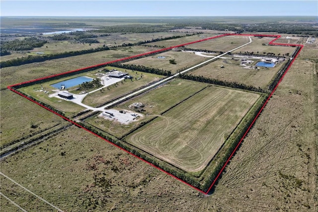 drone / aerial view with a water view and a rural view