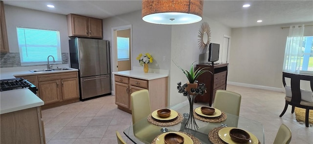 401 N 29th St, Fort Pierce, FL 34947 - kitchen featuring freestanding refrigerator, light tile patterned flooring, range with gas stovetop, light countertops, and recessed lighting