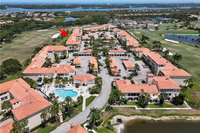 5030 Harmony Cir Unit 204, Vero Beach, FL 32967 - aerial view of property and surrounding area featuring a golf course, a large body of water, nearby suburban area, and a pool area