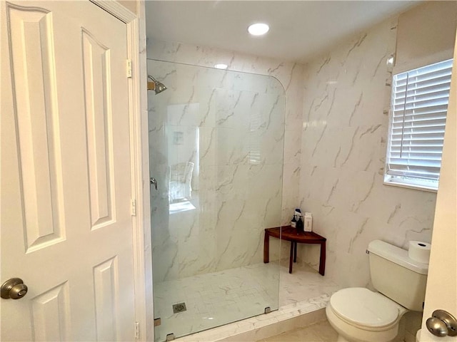 bathroom with tiled shower and toilet