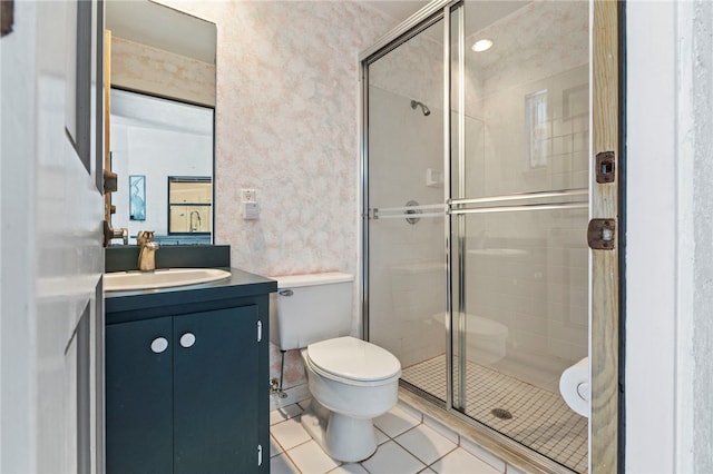 bathroom featuring vanity, a shower with door, tile patterned floors, and toilet